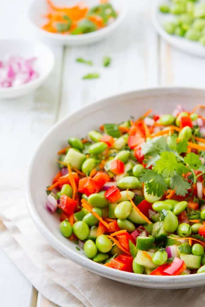 This easy Asian Edamame Salad with ginger vinaigrette makes a terrific main or side dish. Great for lunches, read on for how else to use this simple salad!