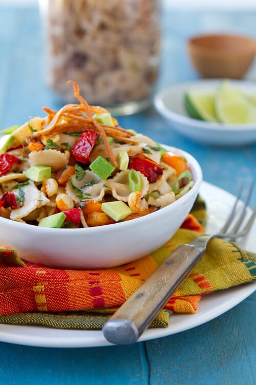 Bell peppers, avocado, whole wheat pasta and crispy tortilla strips all wrapped up in a zippy dressing make this Mexican Pasta Salad a salad you will crave again and again!