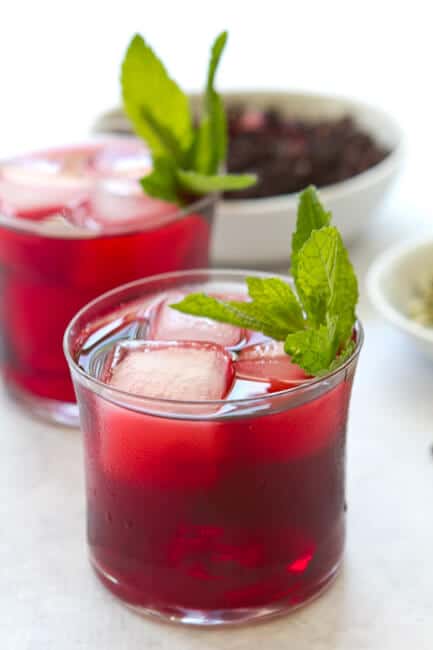 two glasses of hibiscus and cardamon cooler.