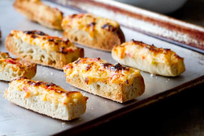 This Easy Queso Dip Bread recipe has it all - gooey cheese, tomatoes and spicy chiles! Make a big batch ahead and enjoy gooey, cheesy Queso anytime! 