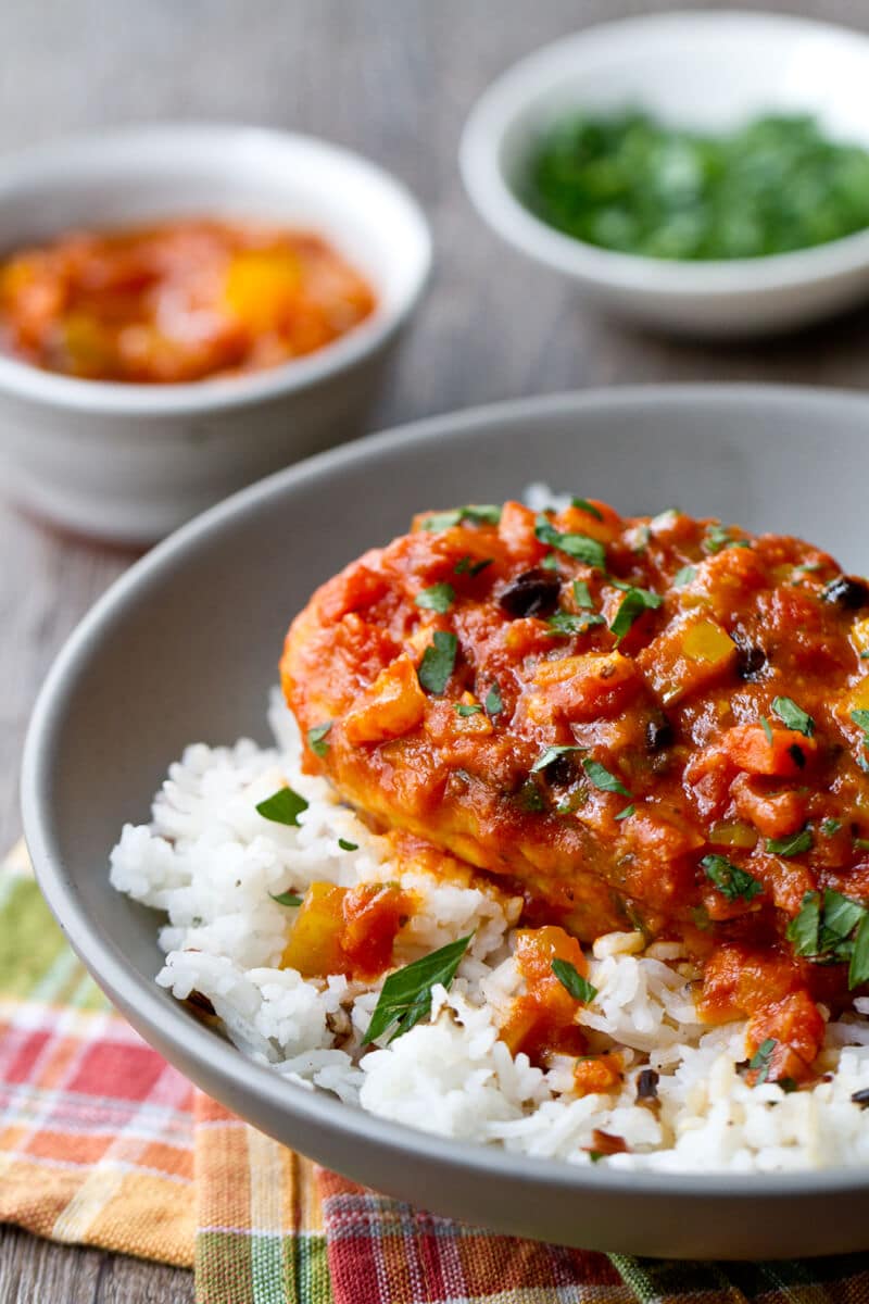 Close up photo of Country Captain chicken in a bowl over rice.
.