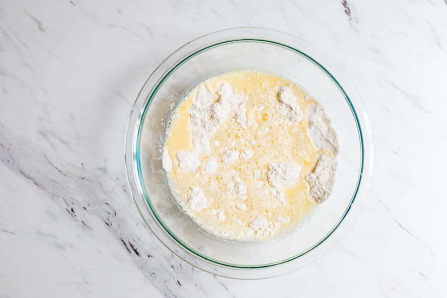 tarte-flambee-french pizza-crust -ingredients Bowl with wet and dry ingredients for the Tarte Flambee crust.