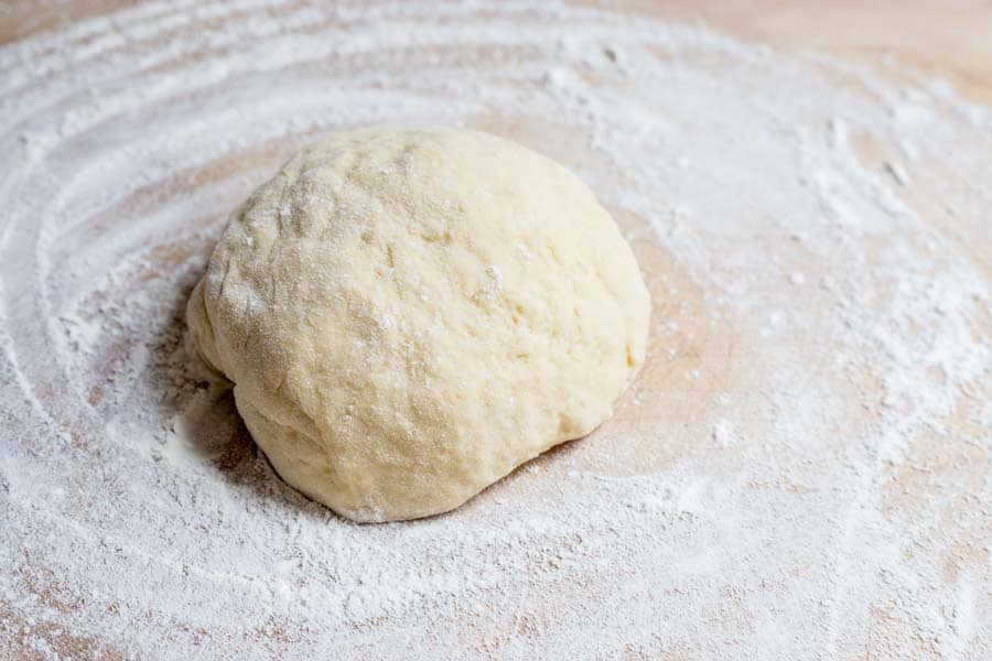 Tarte-Flambee-dough. Dough on a floured board ready to be rolled out for the french pizza.