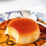 Close up photo of Spanish flan recipe with a portion removed to show the interior.