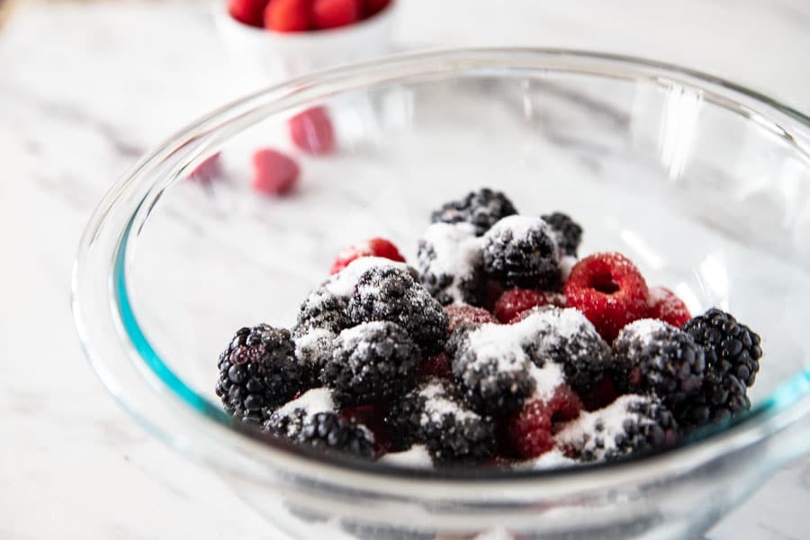 bowl of berries with raspberry liqueur and sugar. 