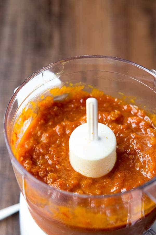 Sweet, sour and spicy, this Tomato Chutney is everything you love about ketchup - but better! Flavored with ginger , curry and a little chile, you'll want to slather this chutney on everything - chicken, fish, steaks, sandwiches and vegetables! A quick saute and simmer is all it takes for this riff on an Indian classic! Tomato chutney in a food processor after being blended.