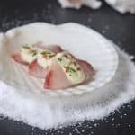 A Thai inspired hamachi appetizer with a coconut milk, lemongrass and lime juice vinaigrette.