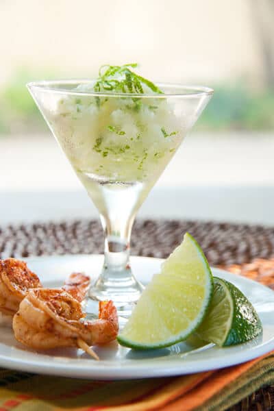 A cocktail and appetizer all in one! An updated frozen margarita is paired with spicy shrimp an easy Mexican inspired dish for easy, summer entertaining.