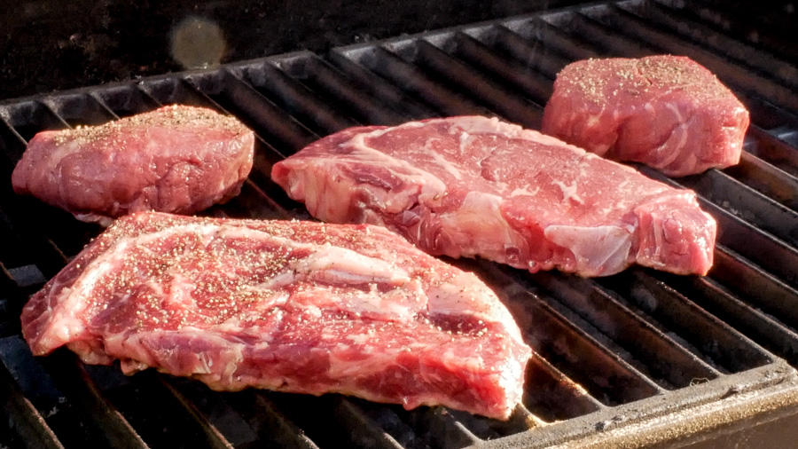 Step #2 for grilling ribeye steaks - steaks on the grill. 