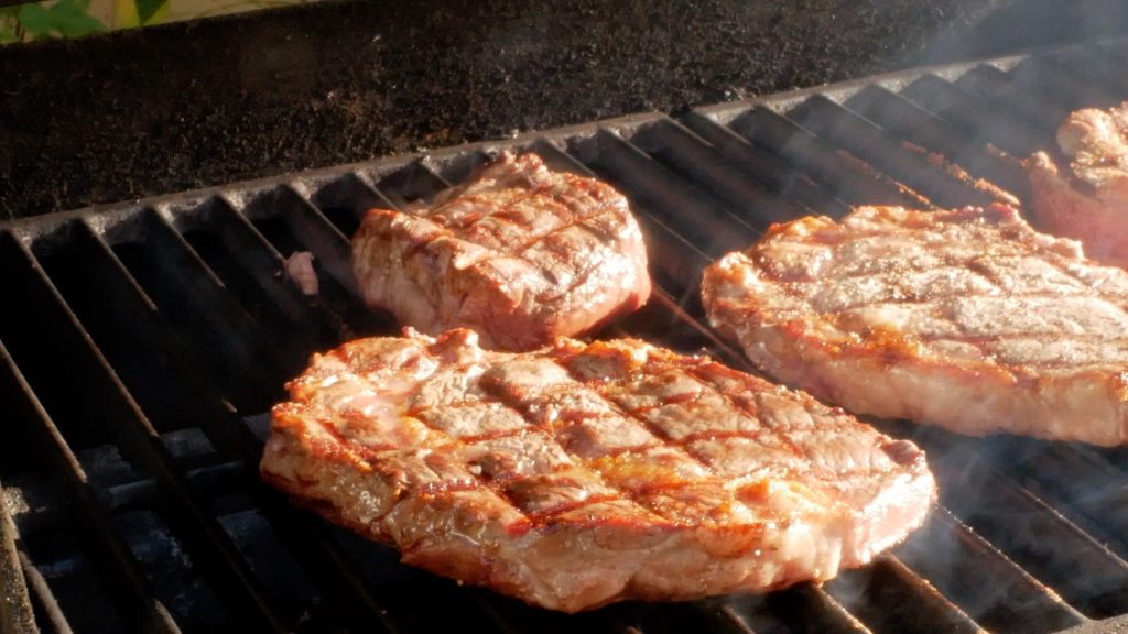 Step #3 in grilling steaks - steaks on the grill after they have been turned. 