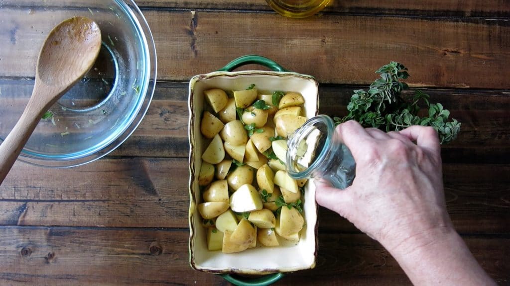 pouring water over the greek potatoes 