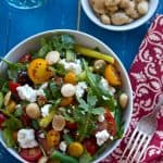 Easy and healthy Mediterranean Quinoa Salad recipe with a lemon vinaigrette. Tomatoes, arugula, feta and almonds combine in this make ahead side dish!