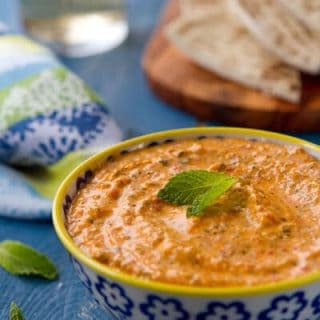 Kopanisti dip - a spicy and creamy dip from Greece, is flavored with red peppers, feta and mint. An Incredibly easy and delicious dip for any occasion.