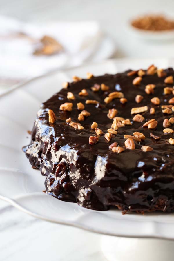 Close up of Ooey Gooey Chocolate Cake on a cake plate. 