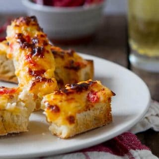 This Easy Queso Dip Bread recipe has it all - gooey cheese, tomatoes and spicy chiles! Make a big batch ahead and enjoy gooey, cheesy Queso anytime!