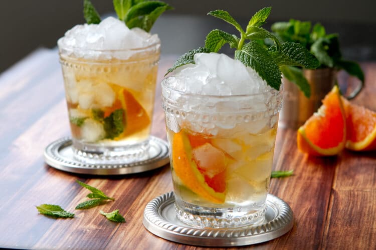 A riff on the Kentucky Derby classic Mint Julep, this Orange Mint Julep recipe is a great introduction to bourbon cocktails!
