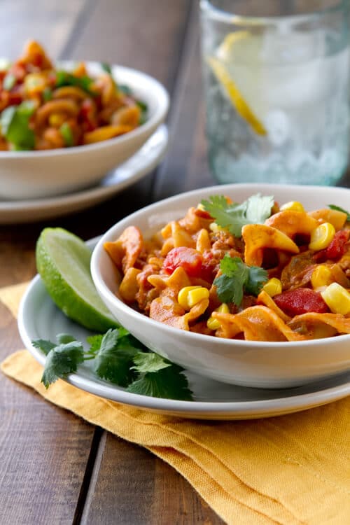 One pan, 30 minute easy mexican style Chorizo Skillet Pasta is filled with tomatoes, chiles and corn and wrapped in a creamy sauce.