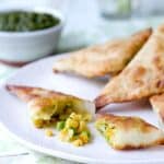 These shortcut vegetarian Samosas with Mint Chutney are filled with potatoes, peas and lentils and ready in under 45 minutes.