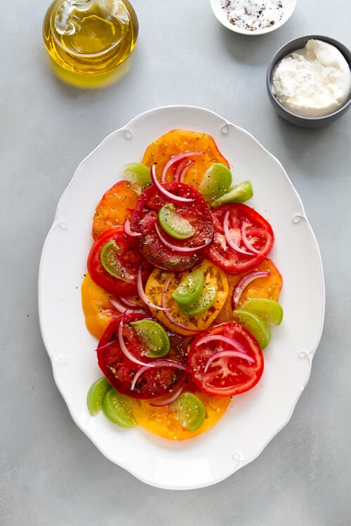 Tomatillos add a bright note to this healthy summer Tomatillo and Tomato salad recipe. Add burrata or avocado and dinner is served!