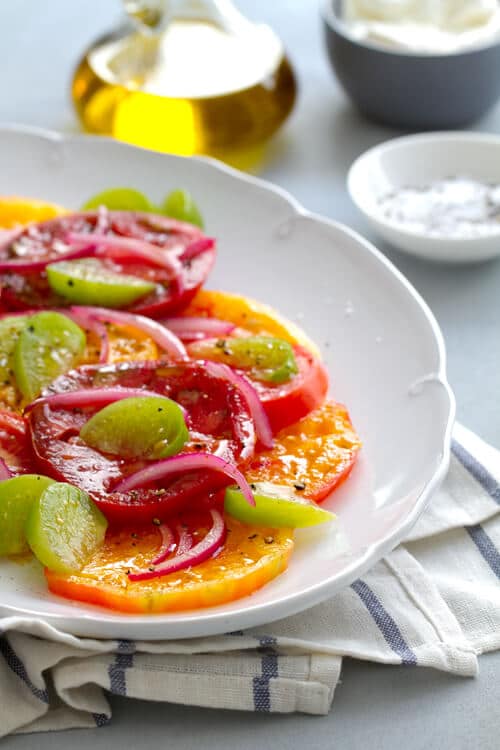 Tomatillos add a bright note to this healthy summer Tomatillo and Tomato salad recipe. Add burrata or avocado and dinner is served!