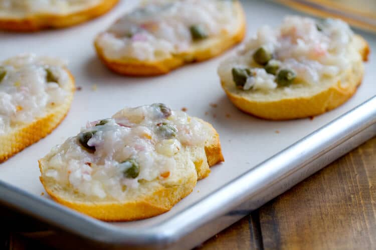 shrimp toasts on a sheet pan ready to be baked. 