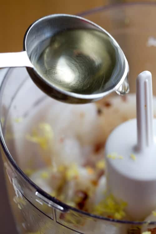 Adding wine to the food processor for the shrimp toast.