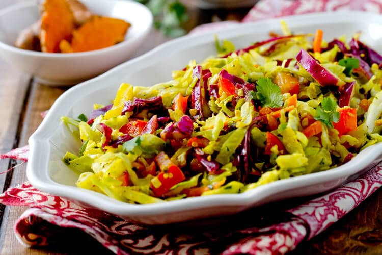 Indian spiced coleslaw with fresh turmeric, coconut, lime, chilis and cilantro