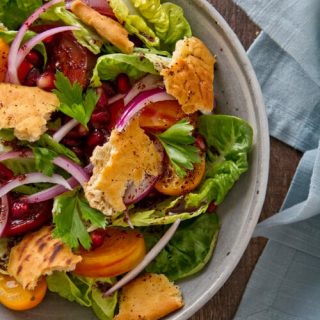 This Pomegranate Fattoush Salad riffs on the classic with pomegranate seeds and sumac with a sweet and tart flavor.