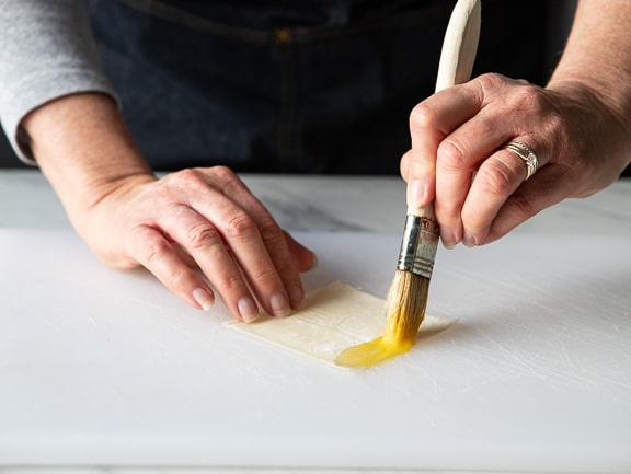 brushing the wonton wrapper with egg wash.