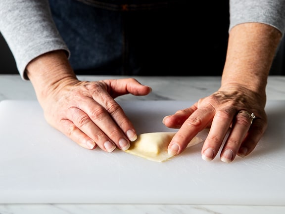 folding a sealing the crab rangoon wonton.