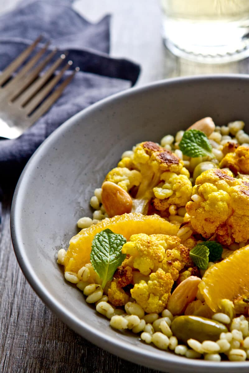 a bowl of moroccan citrus, caulilfower and barley salad