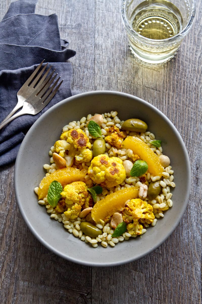 a bowl of moroccan citrus, cauliflower and barley salad