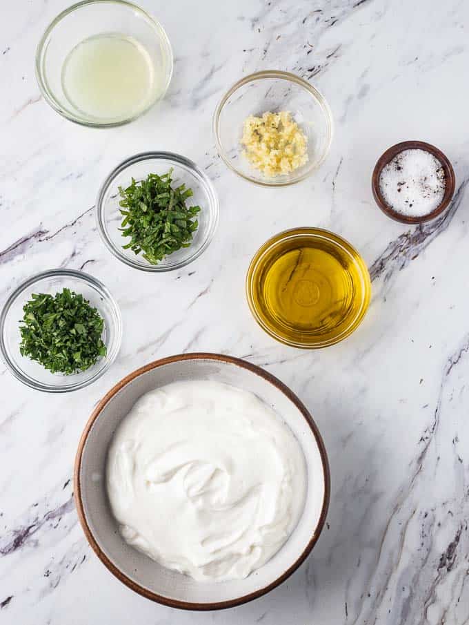 Overhead shot of all the ingredients needed to make Greek Yogurt marinated chicken. 
