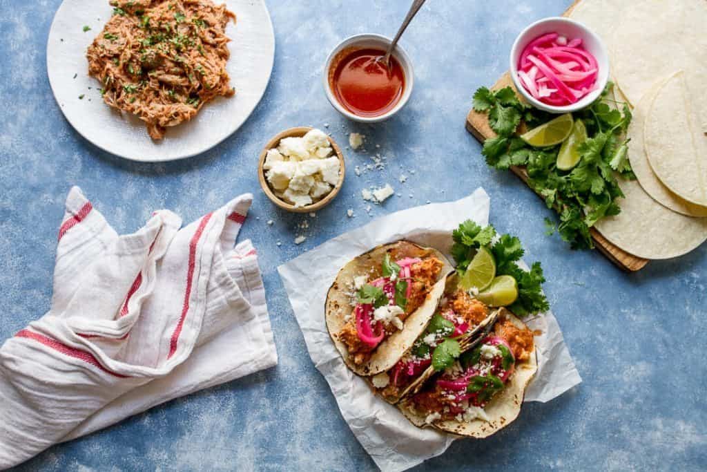 Juicy, tender and made in the slow cooker these mexican style pulled pork tacos have an earthy, citrusy flavor and are almost effortless! 