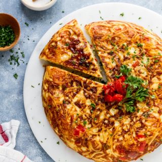 Eggs, cheese and red peppers come together in this easy Leftover Spaghetti Pasta Frittata. See my tips for this easy meal to have for dinner or brunch!