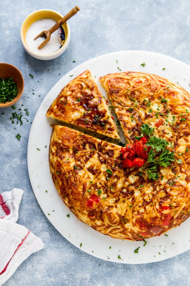 Eggs, cheese and red peppers come together in this easy Leftover Spaghetti Pasta Frittata. See my tips for this easy meal to have for dinner or brunch!