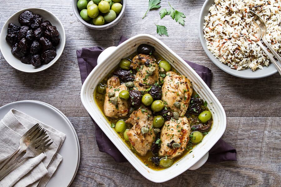 Overhead photo of Chicken marbella recipe with a bowl of wild and white rice.
