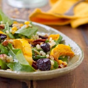This Roasted Delicata Squash Salad with Apple Butter Vinaigrette recipe bursts with fall flavors! No peeling required and ready in under an hour!