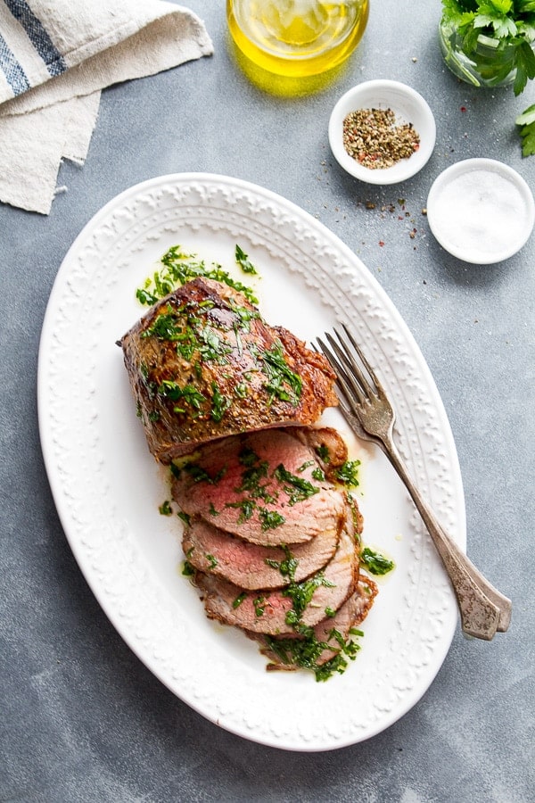 Platter with slices of Tender Eye of Round Roast with Herb Infused Oil 