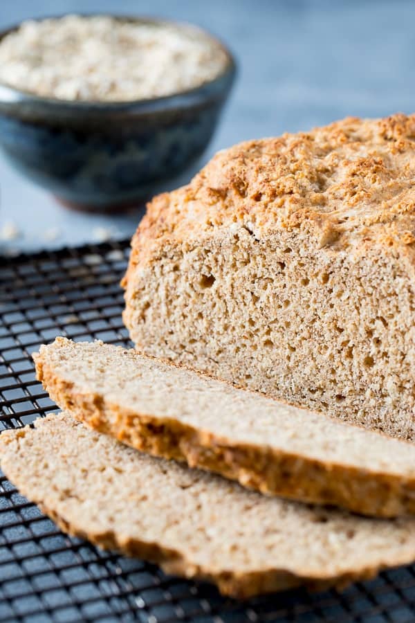 sliced loaf of irish brown bread on a cooling rack.