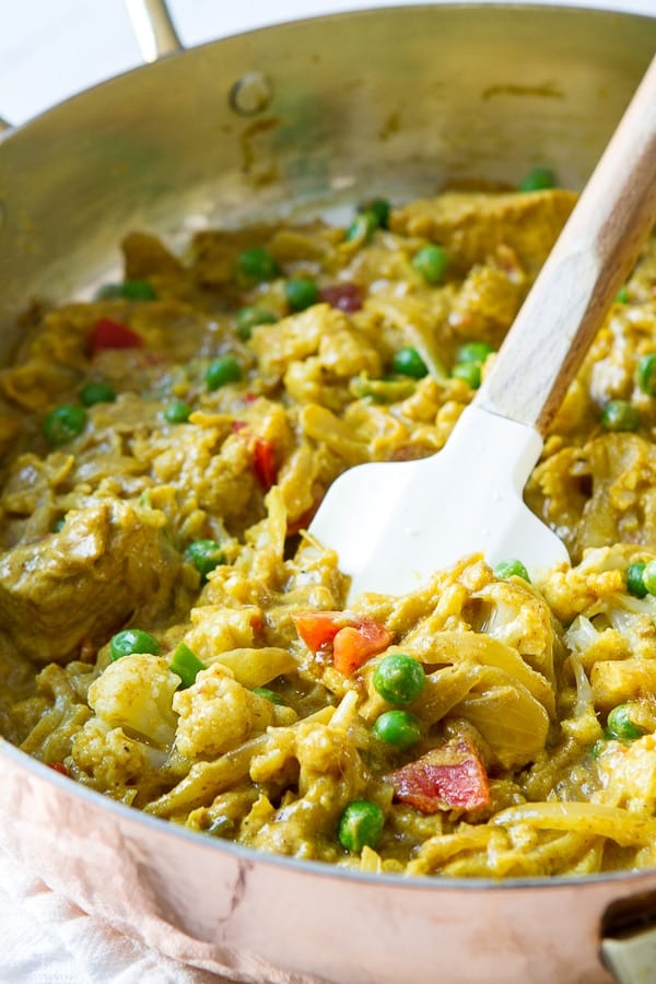 Skillet with remaining ingredients for coconut chicken curry.