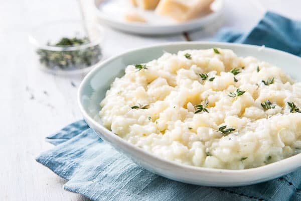 Bowl of Weeknight Instant Pot Parmesan Risotto with a napkin. 