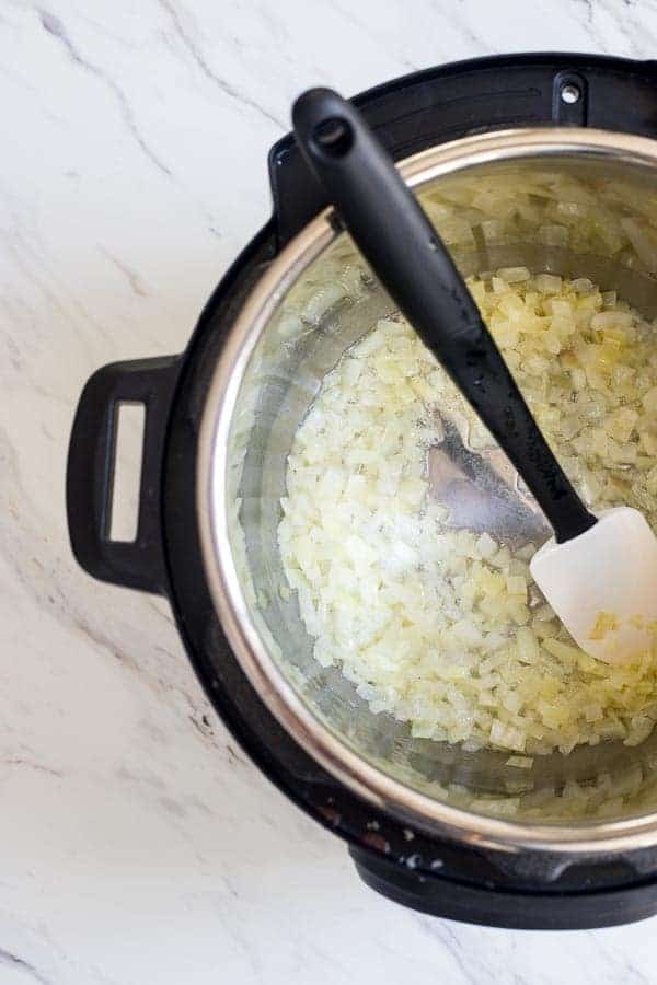 Sauteed onions in the Instant pot for Weeknight Instant Pot Parmesan Risotto. 