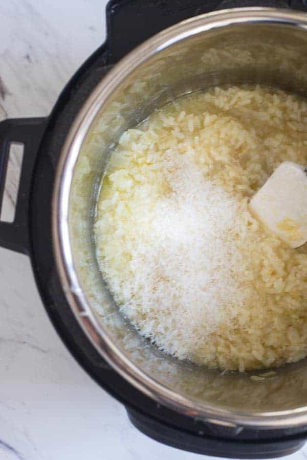 Parmesan being stirred into weeknight instant pot parmesan risotto 