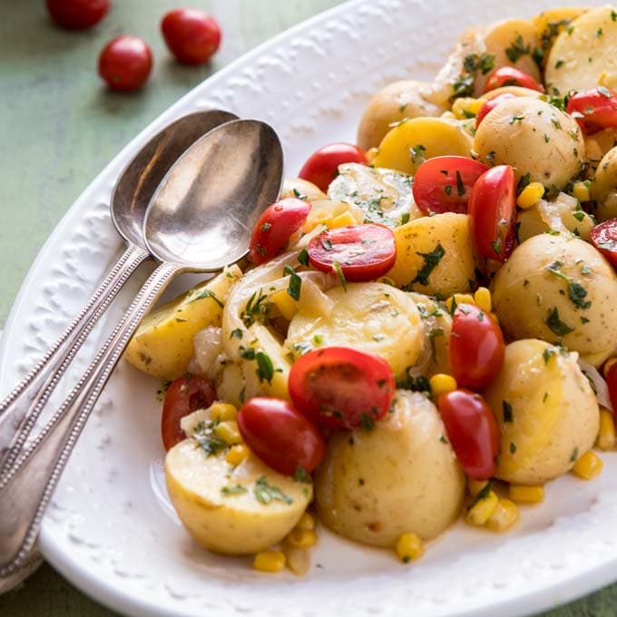 Close up of pressure cooker potato salad with two spoons for serving. 
