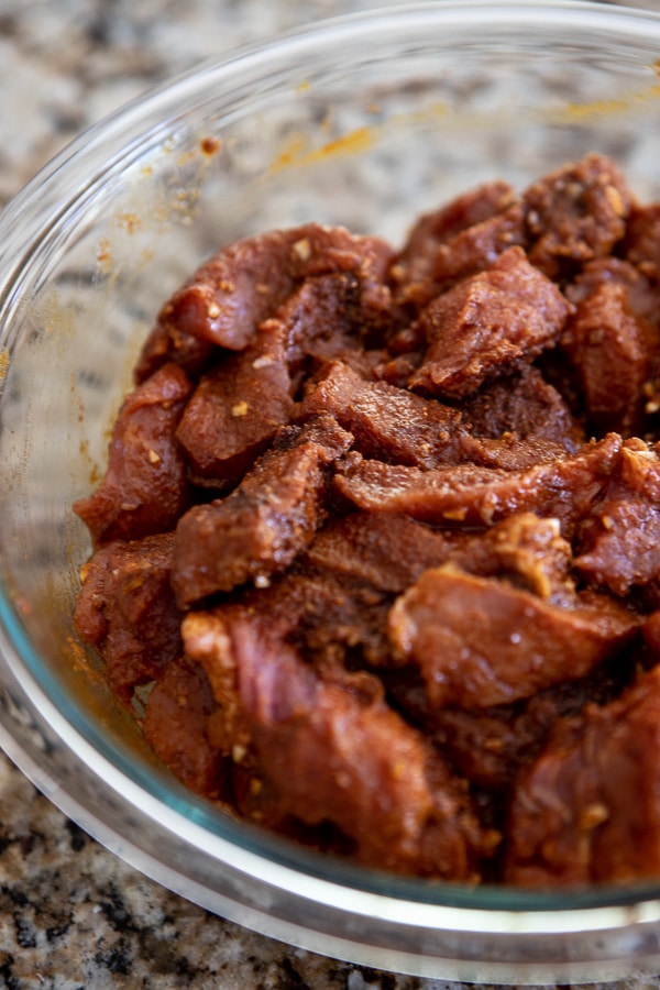 pork tenderloin in a bowl marinating.