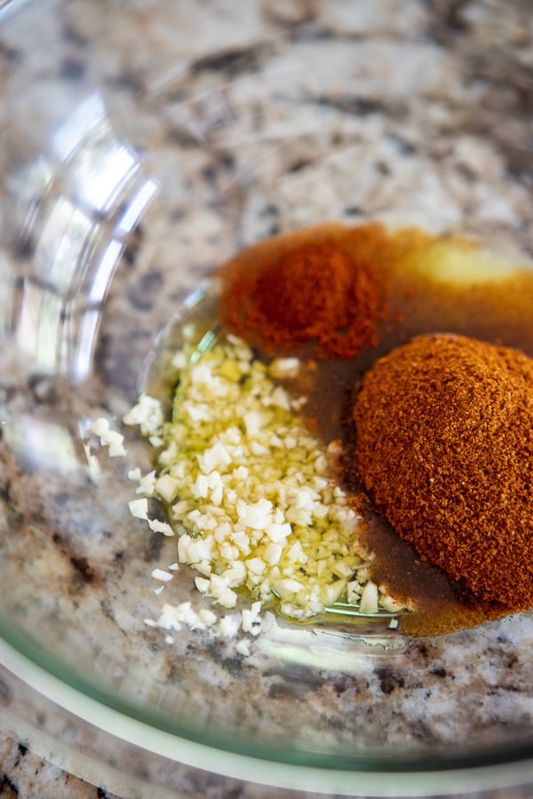 mixing bowl with ingredients for ras el hanout grilled pork skewers