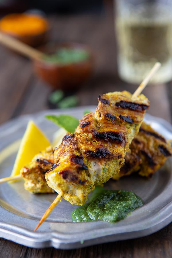 Murgh Tikka or chicken tikka on a plate with mint chutney