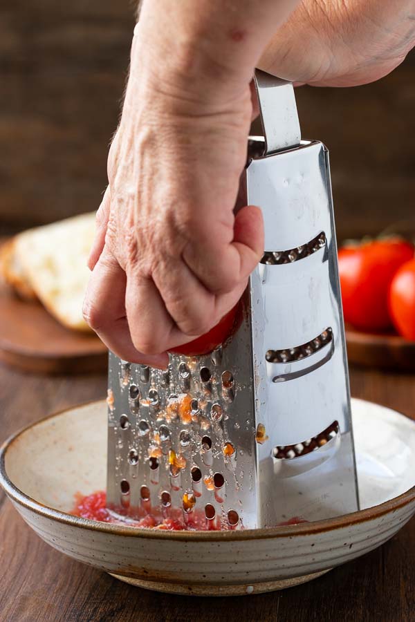 grating tomatoes for pan con tomate.