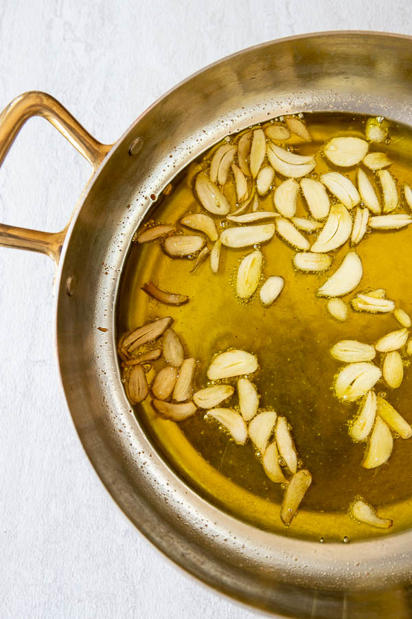 Sliced garlic in olive oil for the gambas al ajillo